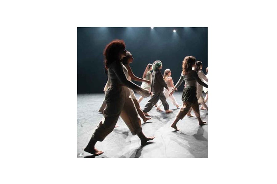 Photo of dancers in a performance walking in sync