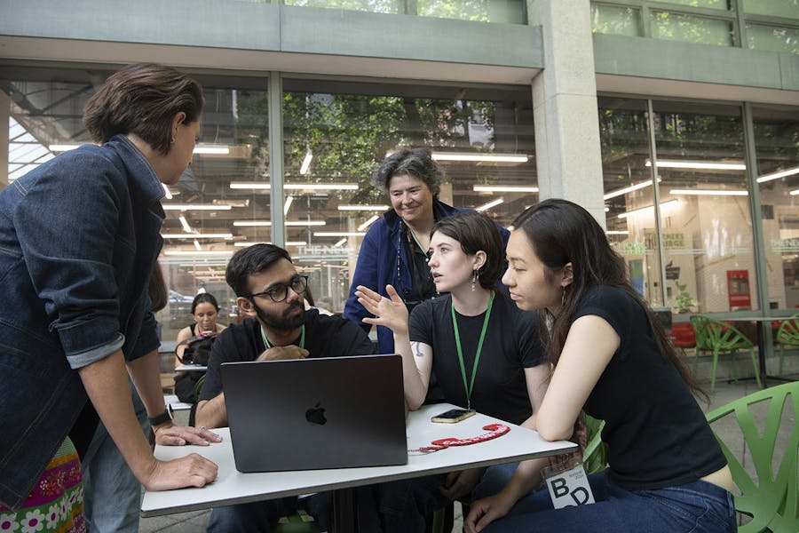 MFA Transdisciplinary Design students Parth Patel and Cherilyn Tan, along with BA/FA student Gretel Dougherty (BA Interdisciplinary Science/BFA Design and Technology) discuss with faculty members Carolina Obregon and Jane Prione their entry in the competition’s category for projects reflecting critically on biodesign.