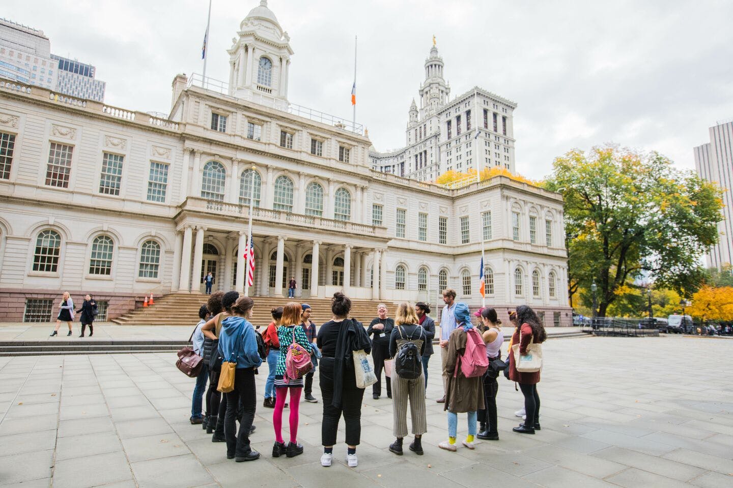 Students gather in front of a large building.