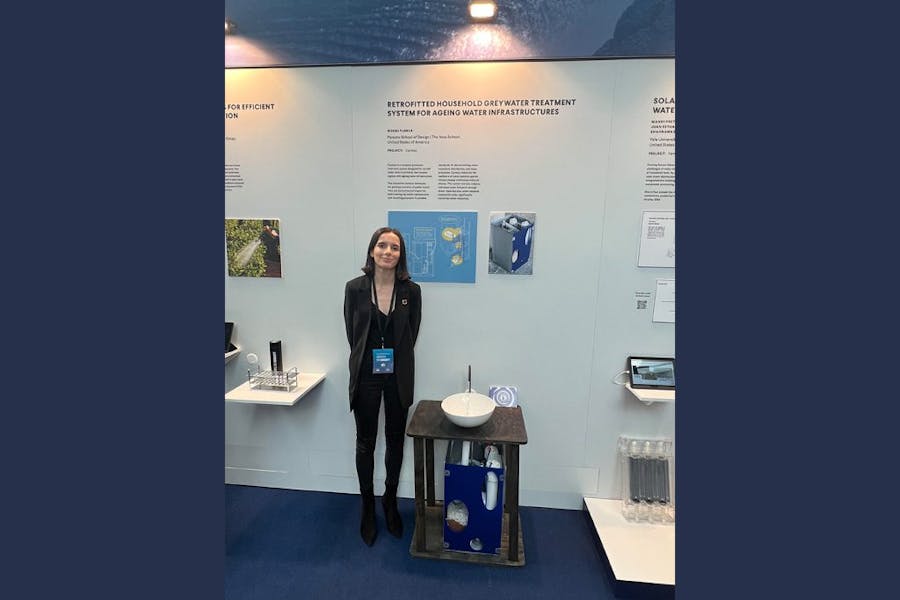 Noemi Florea stands by her exhibit with one her greywater treatment systems