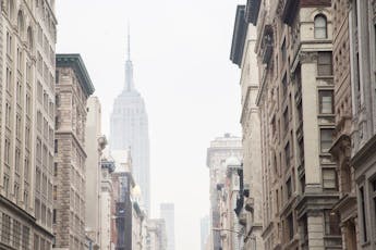 View of Empire State Building from a fog-filled Fifth Avenue in Manhattan