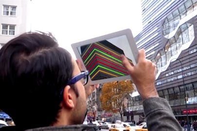 Person holds tablet with building on it up to New School University Center
