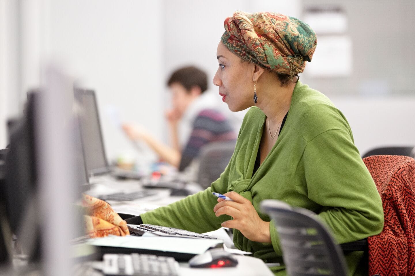 A woman works on a project on a computer.