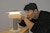 Student carefully adjusts a small, softly glowing lamp.