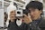 Student peers through a camera viewfinder, preparing to take a photograph.