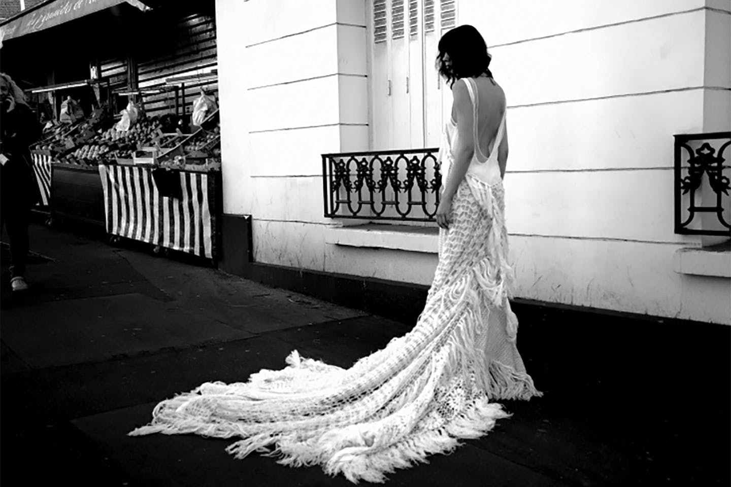 A black-and-white photo by MFA student Wenyi Cai of a model wearing a white gown, inspired by Ann Demeulemeester, designed by Cai’s classmate Yuzi Zhang.