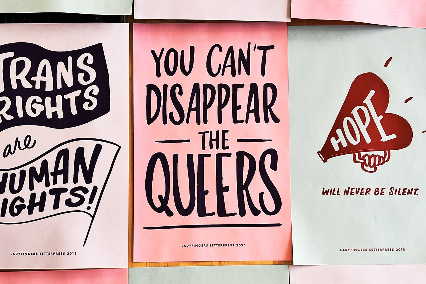 A wall display of Torsone’s hand-lettered posters promoting LGBTQ+ rights created for protests.