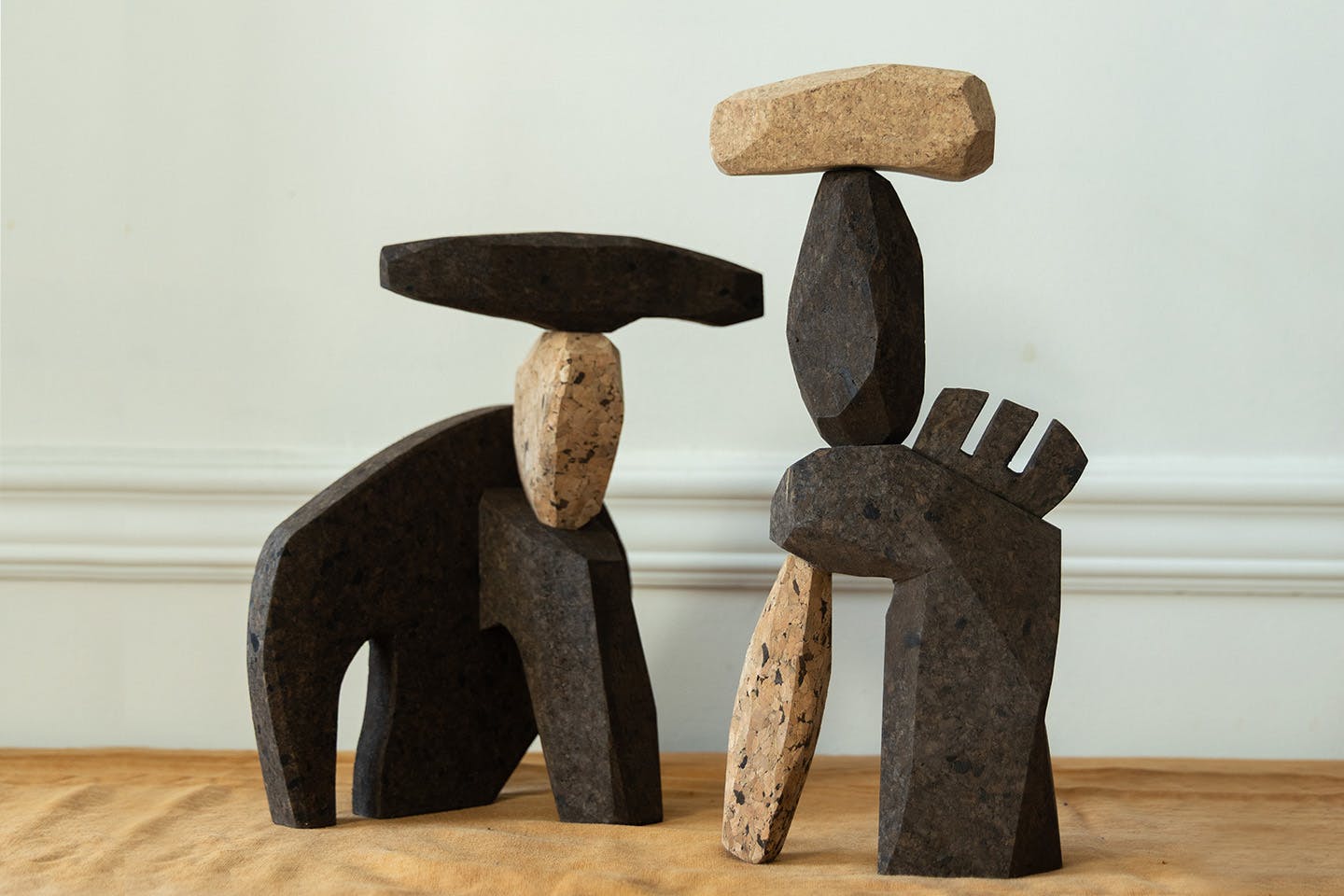 Photograph of Wallin’s cork remover and corkscrew cover are shown alongside other carved cork objects, arranged together as a sculptural tableau.