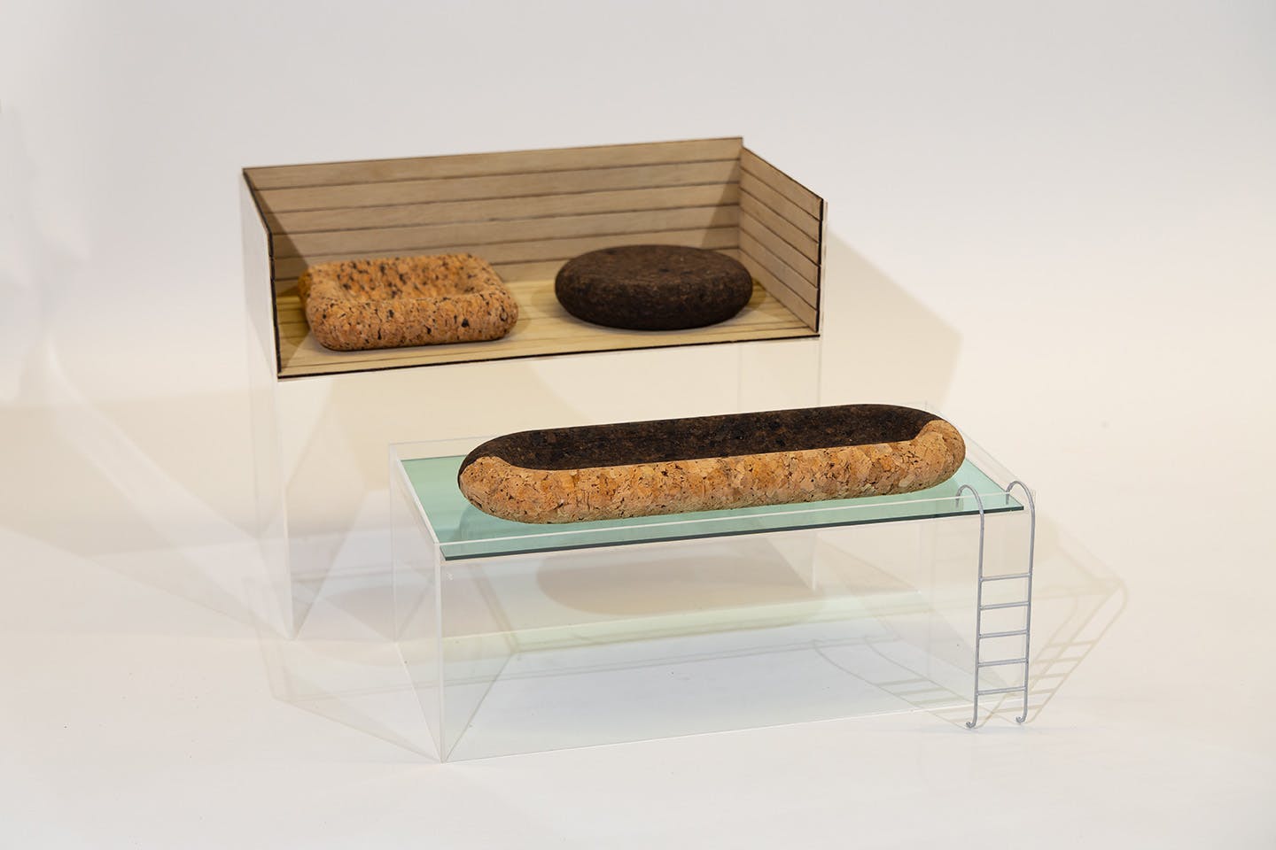 Display photograph of a model of Veronica Speyer’s cork patio and pool furniture suite, designed to float on water and resist mold
