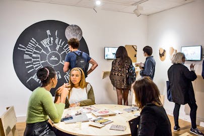 Students view an exhibition in the Project Space, on Parsons Paris’ Saint-Roch campus.