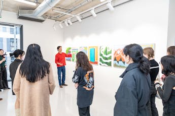 Faculty discuss artworks with a group of students at Parsons Paris Galerie D exhibition space.