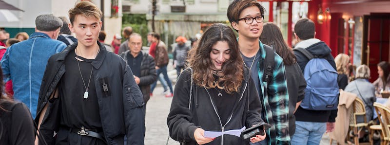Three students walk together in Paris