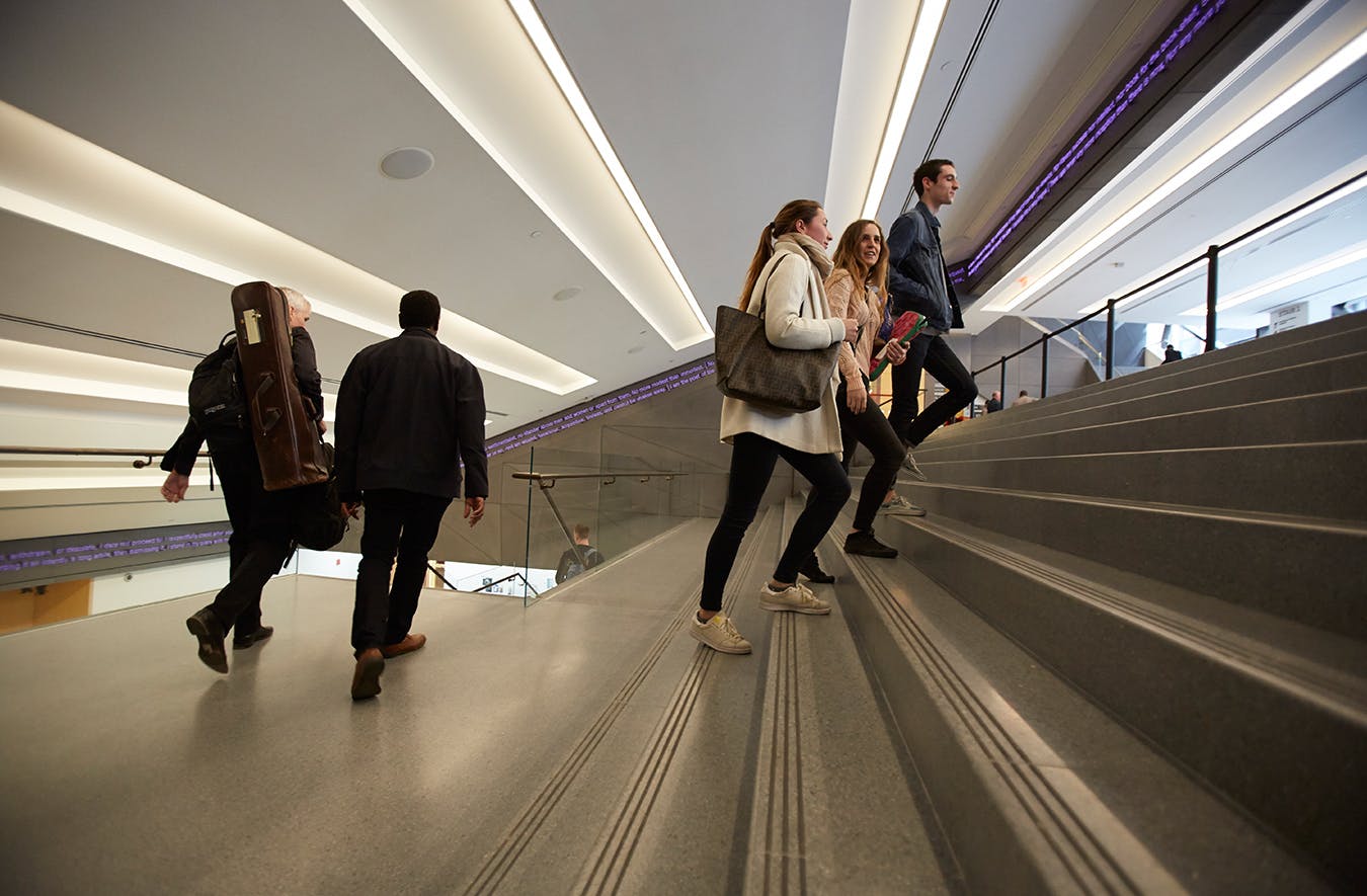 Group of students walking up a stairwell 