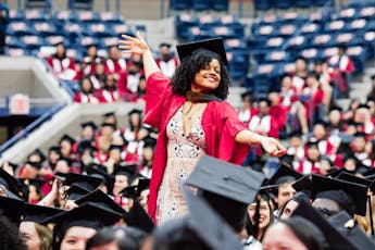 A student celebrates at their graduation ceremony.
