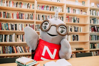 Gnarls Narwhal, the school mascot, studies in the library.