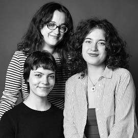 Spitting Image: three people pose in a black and white photo