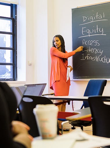 Renowned litigator and New School senior vice president for social justice Maya Wiley stands at a chalkboard, teaching