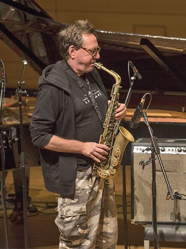 A saxophonist plays on stage at The Stone