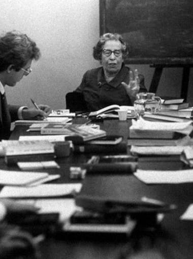 Hannah Arendt speaks to students at a table in the 1960s