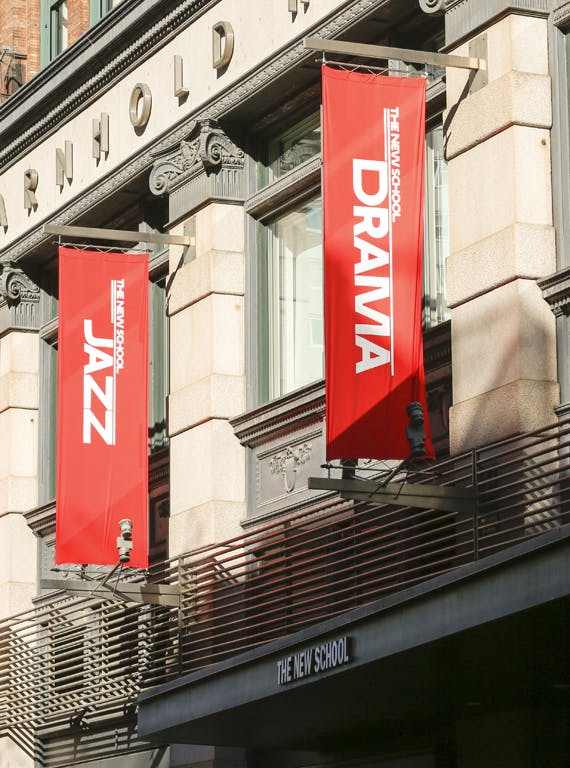 Arnhold Hall in close-up, showing flags for the School of Jazz and the School of Drama at The New School