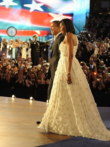 First Lady Michelle Obama, wearing a dress designed by Parsons alumnus Jason Wu, joins President Barack Obama on stage at the first inaugural ball in 2009