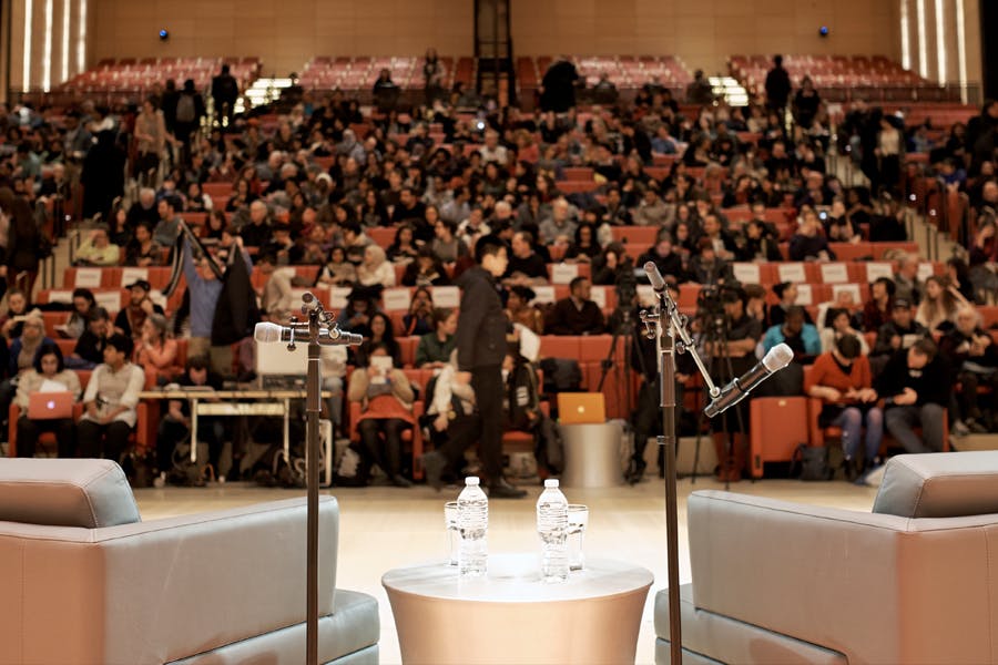 A view of the audience from the auditorium stage where a public program is about to take place.