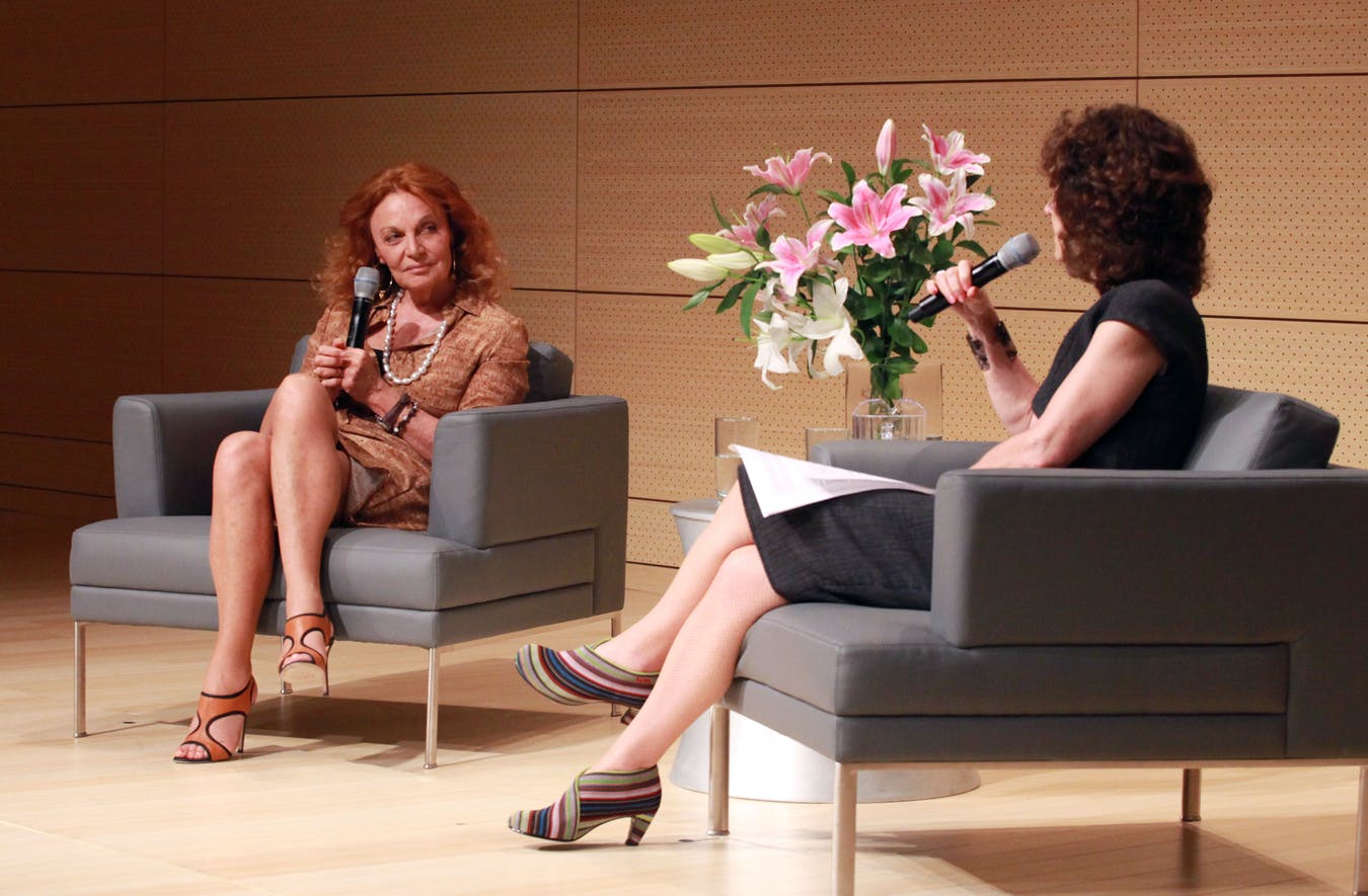 Diane von Furstenberg on stage being interviewed by a faculty member.